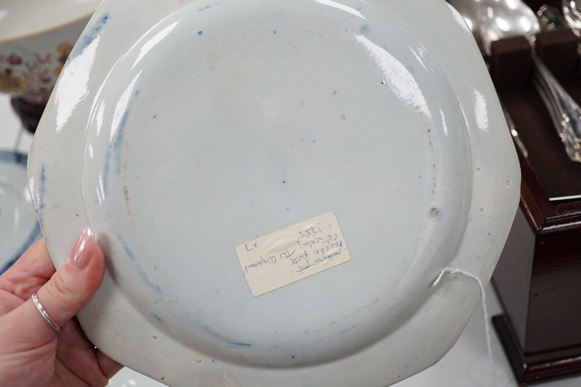 A Chinese export armorial soup plate, for the Spanish market, Qianlong period, with a Spanish coat of arms, possibly Aguado de Las Marismas, an 18th century Chinese export punch bowl on stand, a Chinese blue and white pl